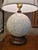Haeger Pottery white ceramic table lamp with lampshade. Circa. 1960. Molded floral pattern to ceramic sphere. Mounted to a...