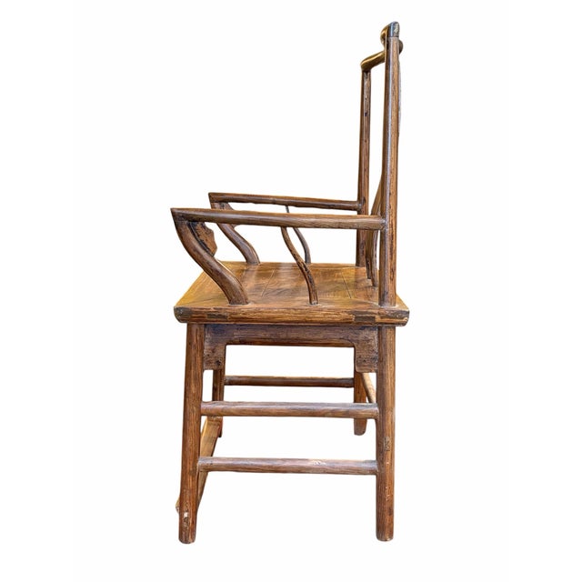 A beautifully crafted vintage Chinese hardwood armchair showcasing traditional Chinese design elements and exceptional...