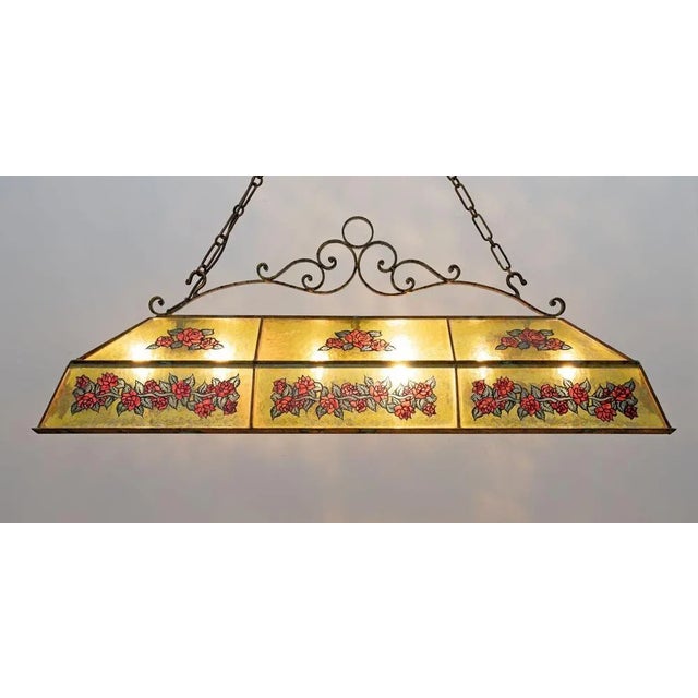 Italian rustic style chandelier in wrought iron and glass with hand-painted decorations. The chandelier is rectangular in...