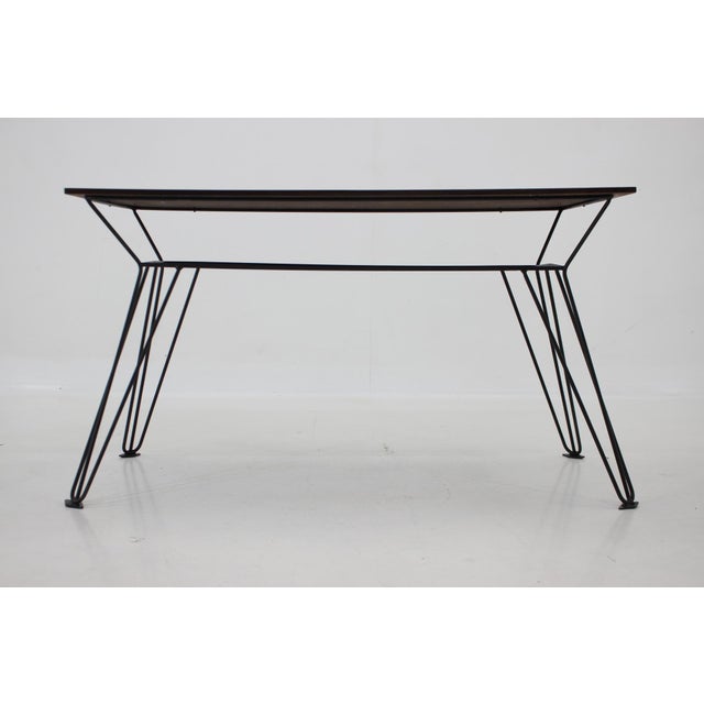 Vintage coffee or side table with wallnut veneer top and metal legs, produced in former Czechoslovakia in the 1970s....