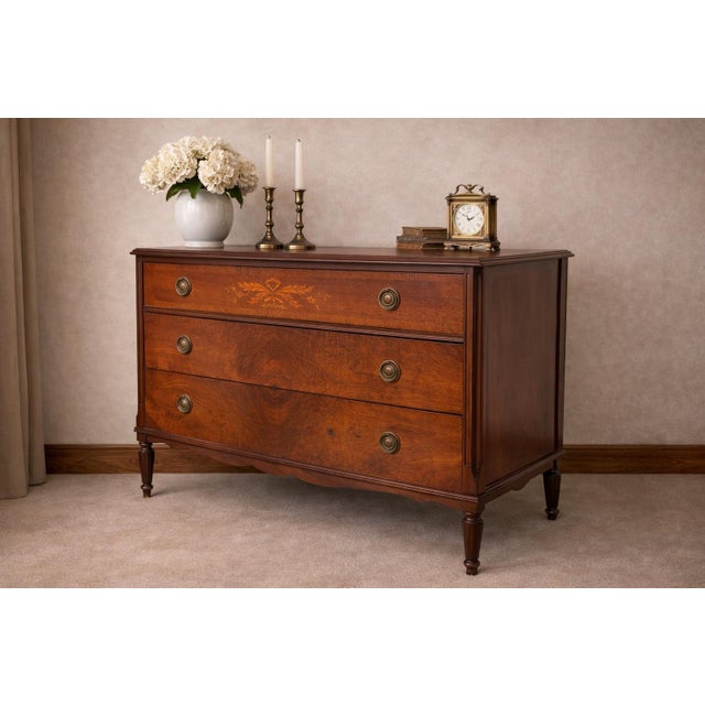 This antique three-drawer dresser is crafted from richly figured mahogany and retains its original finish and naturally...