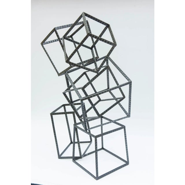 This monumental and arresting stacking cube welded steel sculpture has many angles and forms of cubes. Some are stacked at...