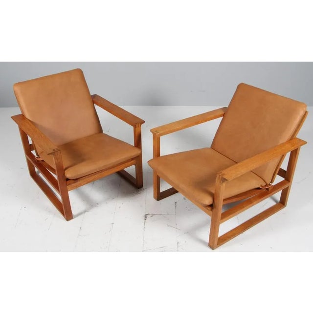 Børge Mogensen lounge chairs new upholstered with cognac vintage full grain aniline. Frame of oak. Model 2256, made by...