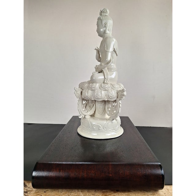 Chinese DeHua porcelain seated Buddha on a lotus throne, a finely carved and detailed seated Buddha in padmasana,...