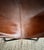 Vintage leather butterfly chair with cognac leather sling seat and black metal frame. Natural patina and visible seam...