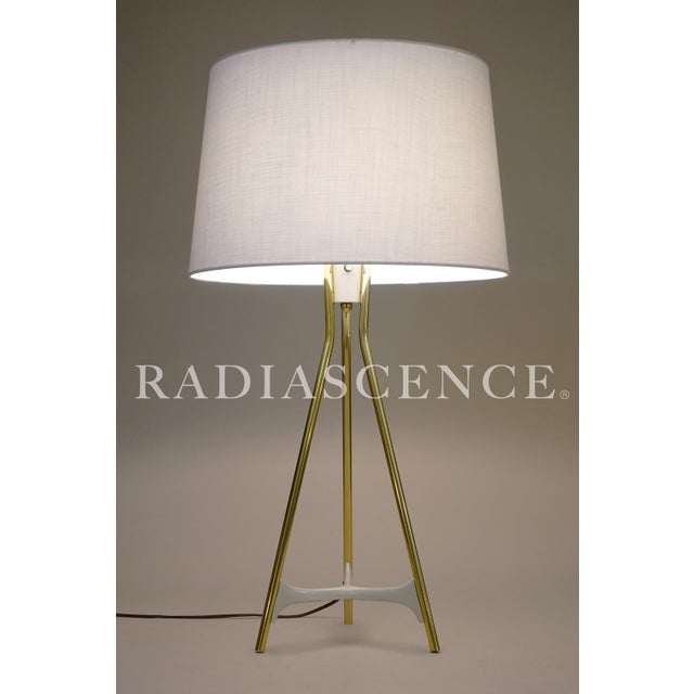 A minimal yet futuristic Atomic Space Age Modern tripod Brass table lamp designed by Gerald Thurston and manufactured by...