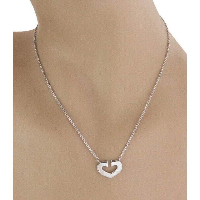 This is a charming authentic necklace by Cartier. It is from C Hearts of Cartier Collection, the pendant is an open double...