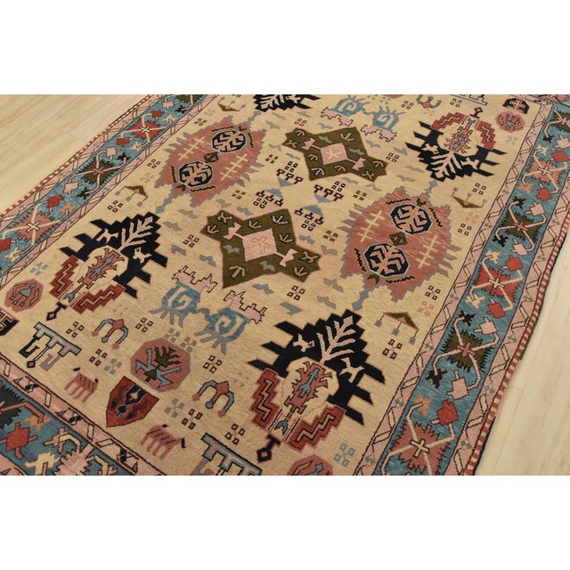An authentic vintage tribal Heriz rug hand-knotted with fine wool on a cotton foundation. This rug features geometric...