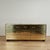 Chic mid century triple dresser crafted in riveted brass panels over a wood frame in sleek modern form with nine drawers...