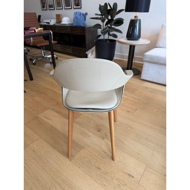 A refined “Frenchkiss” low-back chair designed Attributed to Stefano Bigi for Enrico Pellizzoni, crafted with premium...