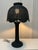 A 1970's Boho Chic style is brought out in this tall wicker table lamp. It's vintage mushroom shaped shade has a scalloped...