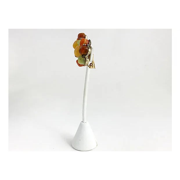 Vintage 1950s Kramer Bead Clip-on Earrings. Green, orange & brown beads surround a yellow bead in a flower design that is...