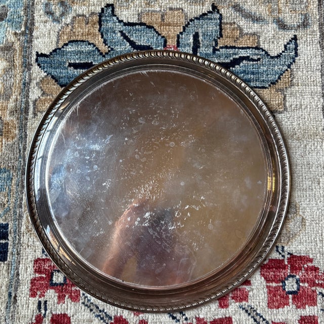 Classic silverplated round serving tray by WM Rogers silver company. Marked Wm Rogers 171. Measures 12." Elegant rope edge...