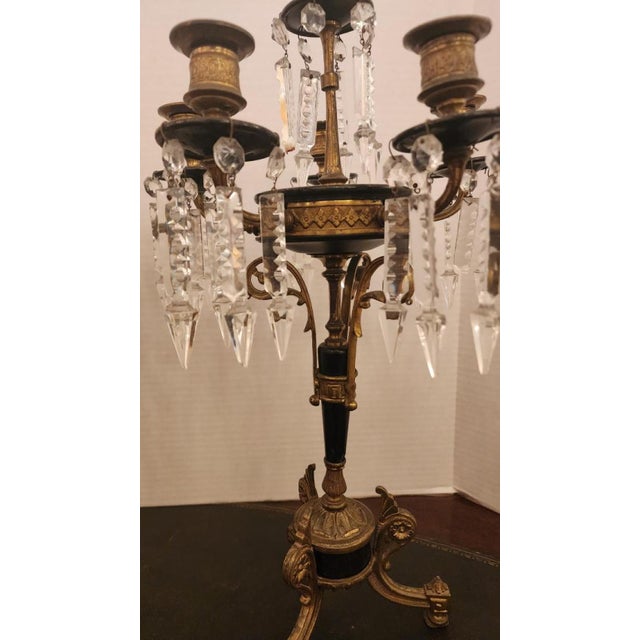This listing features a pair of six candle bronze candelabras with hand-carved hanging crystals that originate around the...