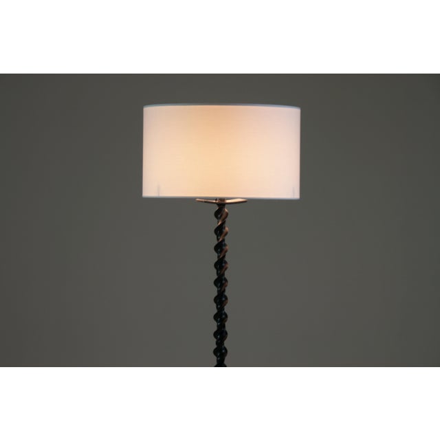 This brutalist tripod floor lamp in twisted black metal makes a strong, sculptural statement. Inspired by brutalist...