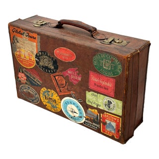 Early 1900s Antique Thick Cowhide Leather Suitcase With Solid Brass Hardware and Many Destination Labels For Sale