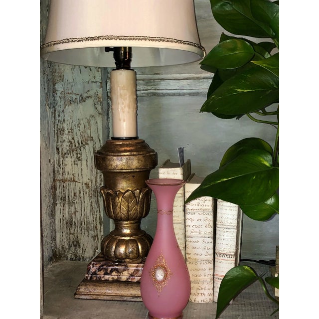 A vintage pink opaline Murano vase with gilt scrolls and colored beading surrounding a cameo style portrait.