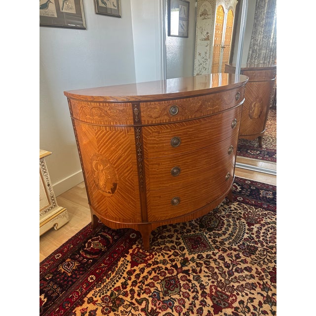 An exceptional Romweber demilune chest distinguished by its graceful silhouette, masterful veneer work, and elegant...