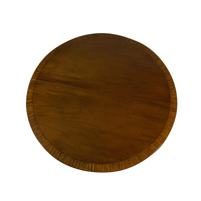 A Regency style inlaid mahogany dining table from the Beacon Hill Collection by the Old Colony Furniture Company of...