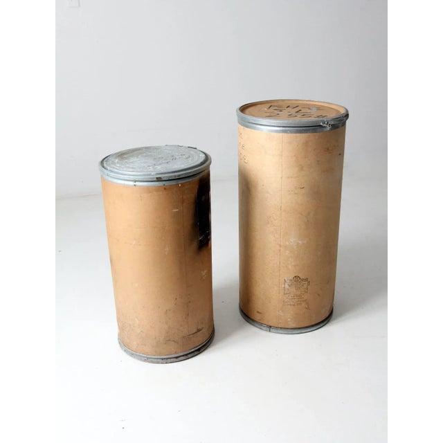 This is a pair of vintage farm bins crafted from sturdy paperboard with metal rims and hinged locking caps. Originally...