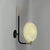 This wall light was designed and manufactured in france in the 1950s. It has a minimalist, modernist design, typical of...