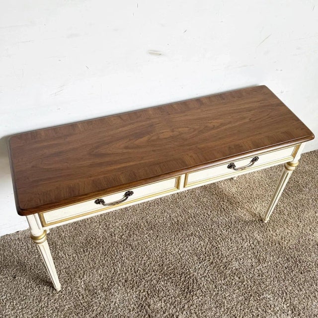Elevate your home with the classic elegance of the Louis XVI Oak and Cream Console Table/Desk by Henredon. This piece...