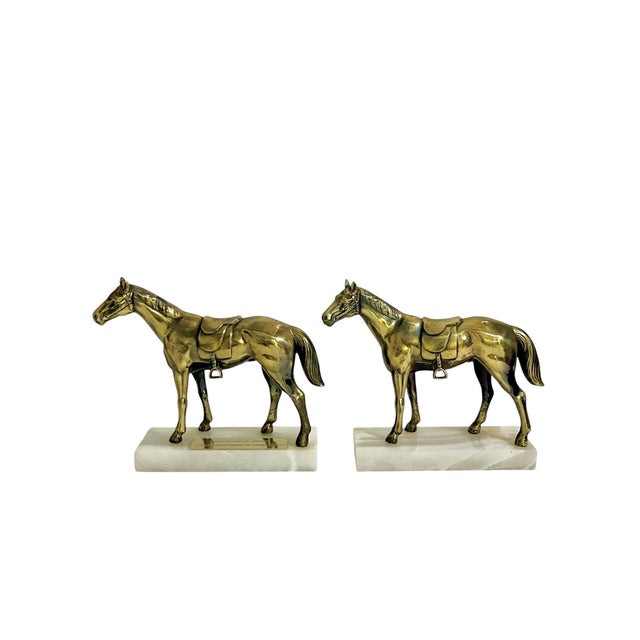 Celebrate timeless equestrian style with this handsome pair of vintage brass horse bookends, each mounted on a white...