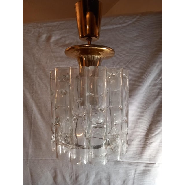 A beautiful pendant lamp, manufactured by doria lighting in the 1960s. The frame is made of metal and brass, as are the...