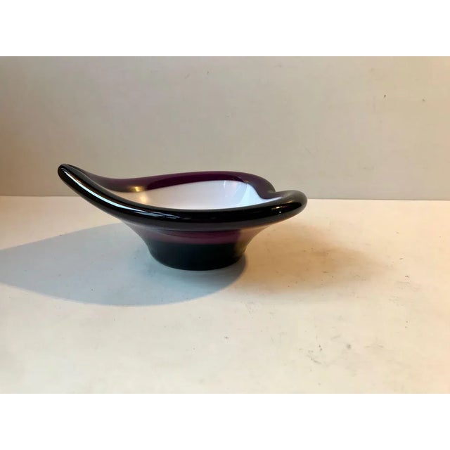 This heart shaped partially collapsed purple and opaline glass dish or ashtray was manufactured and designed by Seguso in...