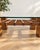 An elegant coffee table made in Italy in the 1970s. The piece stands out for its solid, sculptural wooden structure...