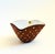 A mid century pottery bowl by Graveren Norsk. Terra cotta exterior with hand painted white dots. Glossy white interior...