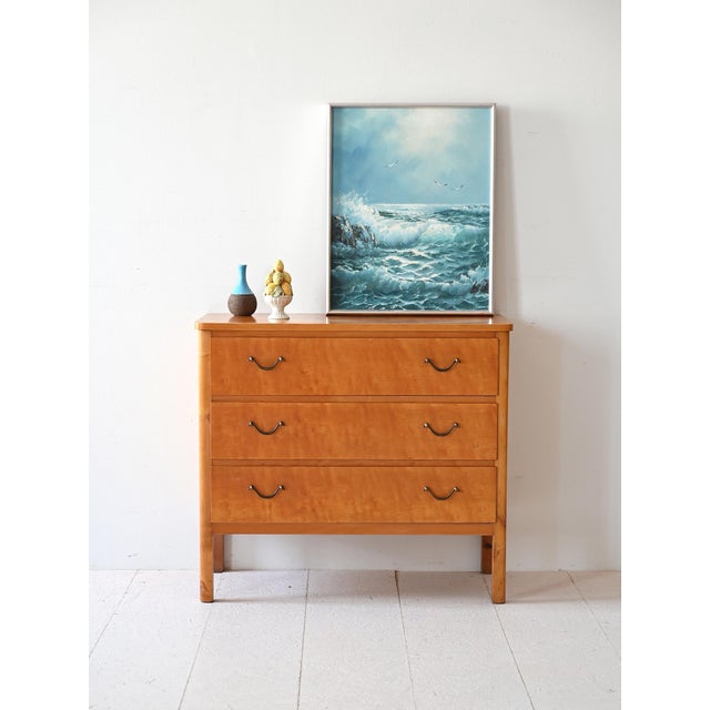 Wooden cabinet with three drawers equipped with lock and metal handles. The briar wood with its marked grains makes this...