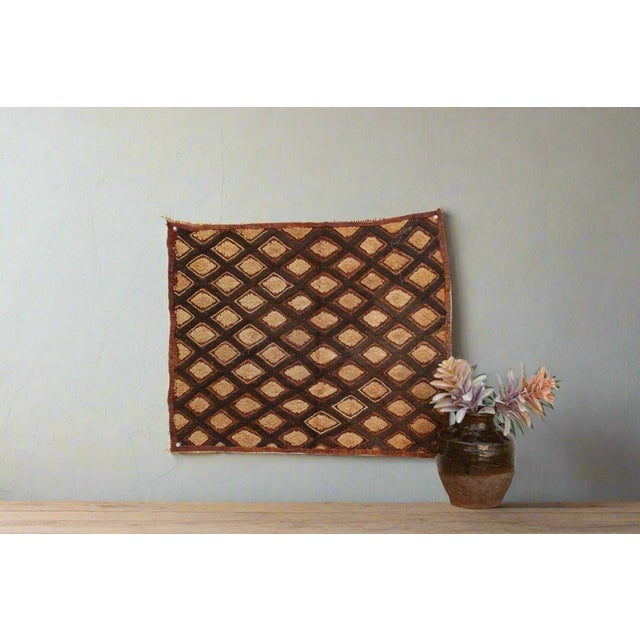 A captivating masterpiece of African textile art, this vintage Kuba cloth panel is a testament to the unparalleled...