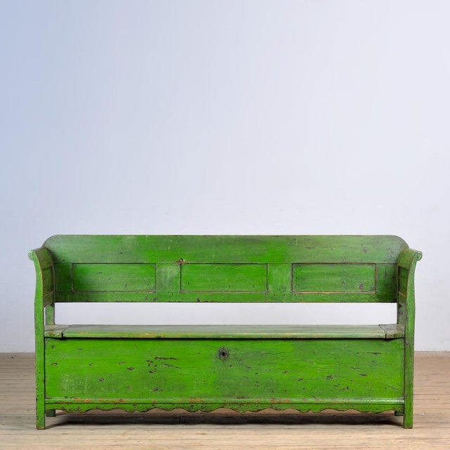 A charming bench from hungary with the original paint. Over time and use, the green paint has been worn away in places to...