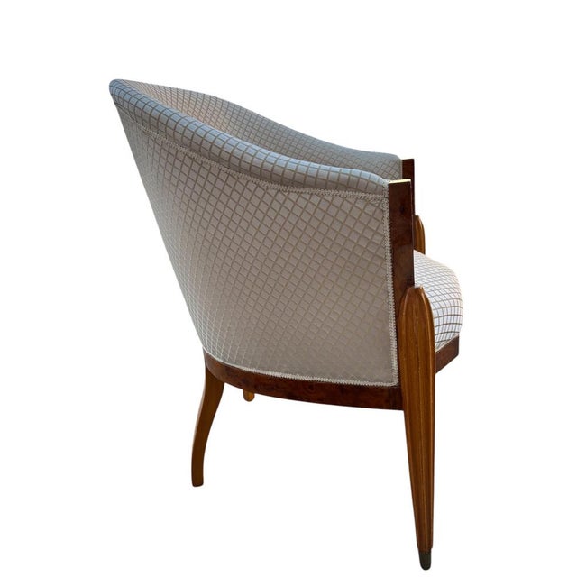 Empire style bucket armchair. The structure is made of wood veneered with burl with visible grain. High-quality...