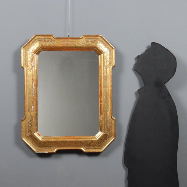 Late 19th-century French cabaret mirror featuring a gilded molded frame enriched with elegant punchwork. The leafy motifs...