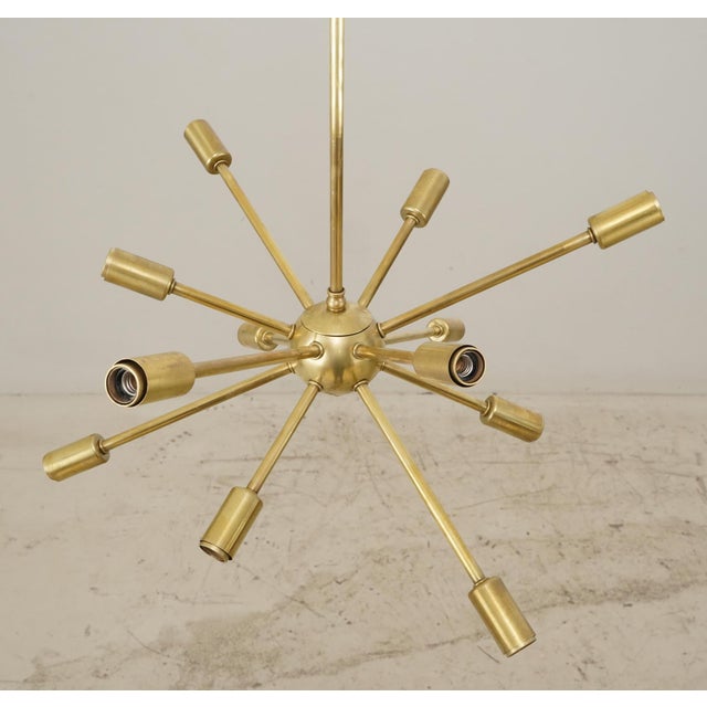 Mid Century modern brass geometric chandelier with twelve arms. Frequently called Sputniks, these Atomic Age starburst...