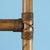 A vintage bamboo etagere with open shelving and a glass top, standing seventy inches tall for display without visual...