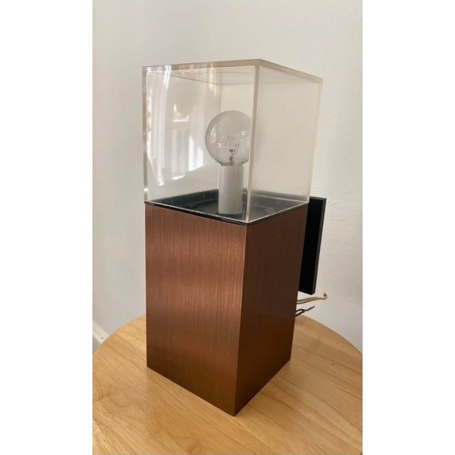 This pair of dual-light sconces made by Lightolier circa the 1970s featuring a plexiglass cube holding the upper light,...