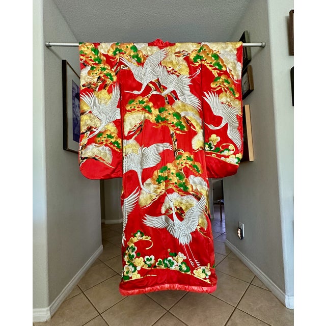 Vintage Uchikake wedding kimono/robe for ceremonial occasions. This bridal outer garment is of red color and decorated...
