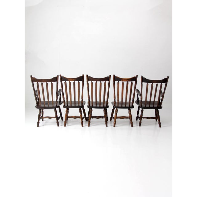A set of five vintage Windsor-style dining chairs, including two armchairs and three side chairs, made in Vermont under...