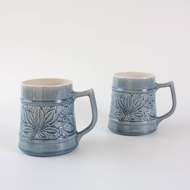 A charming vintage pair of mugs from the 1970s by Secla captures the essence of mid-century design with a distinctly...