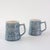 A charming vintage pair of mugs from the 1970s by Secla captures the essence of mid-century design with a distinctly...