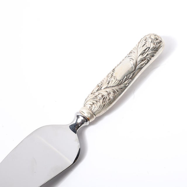 This exquisite sterling silver cake knife by Tiffany & Co., crafted circa 1880, beautifully captures the refined artistry...