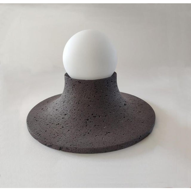 Basalte natural lava stone wall lamp by clemence birot dimensions: ø 25 x h 15 cm materials: stone basalte is a stone lamp...