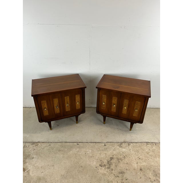 This mid century modern pair of nightstands features hardwood construction, walnut veneer with original finish, two...