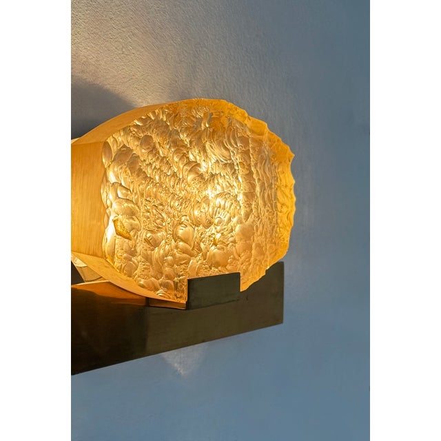 Vintage wall sconce attributed to Serge Mouille, composed of a brass structure and a Dallux resin diffuser, produced in...