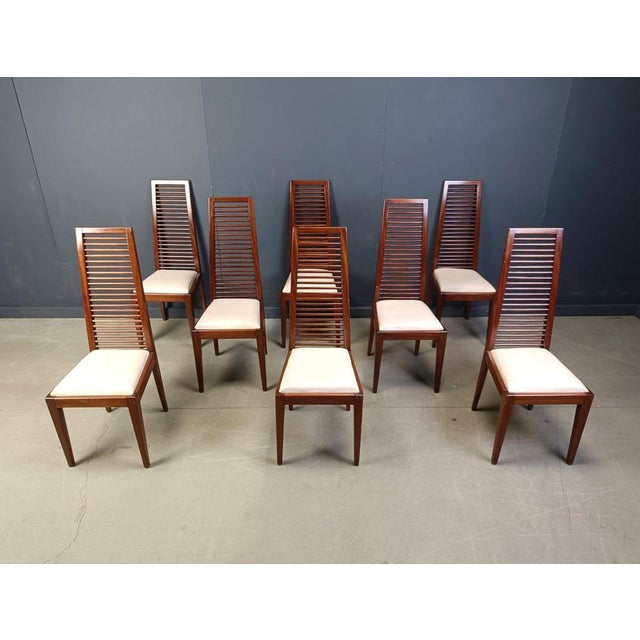 Elegant Italian dining chairs with ladder shaped high back rests. White faux leather seats create a nice contrast with the...