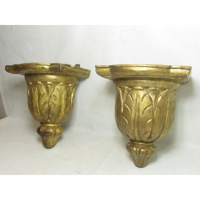 Antique Italian giltwood carved wall brackets, c.1750 Hand carved out of a single piece of wood and finished in gold gilt....