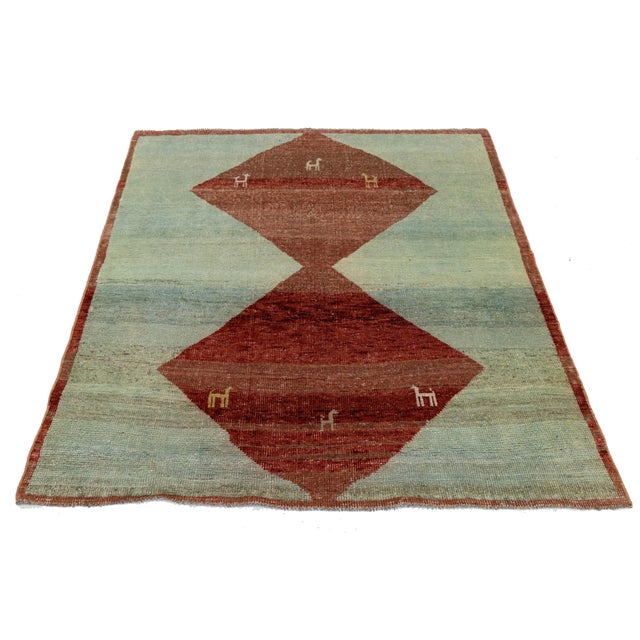 Elevate your space with this stunning hand-knotted Gabbeh rug that blends ancient tribal tradition with contemporary...